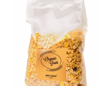 A transparent bag of granola, labelled 'Organic Grain' and '100% Natural.' The mix contains various types of grains and dried fruits.