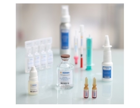 Various medical products, including vials, syringes, and nasal spray, arranged on a table.