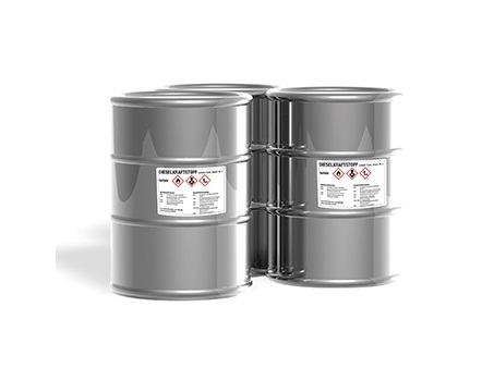 Four silver barrels with warning labels indicating chemical substances. The barrels are stacked on top of each other.