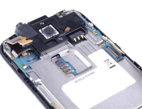 Internal components of a mobile phone, including the camera, SIM card slot, and motherboard.