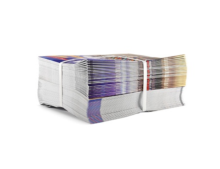 A stack of colorful magazines, neatly bundled with a rubber band, showcases the various cover designs.