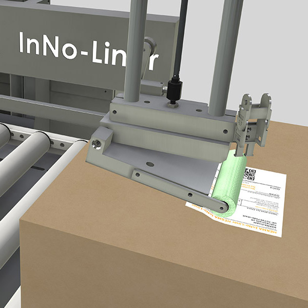 Machine with an attachment for processing materials, labelled 'InNo-Liner,' next to a stack of paper documents.